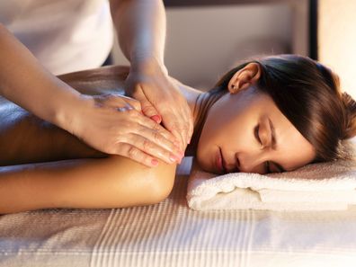 Eine Frau erhält eine entspannende Rückenmassage zur Gewebelockerung.